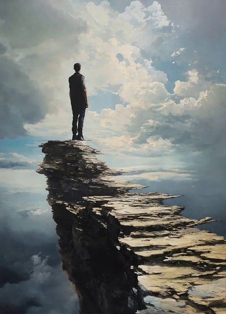 man-standing-on-edge-of-cliff