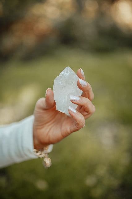 lady-holding-clear-quartz-crystal