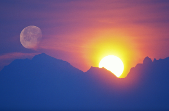 sun and moon on a mountain